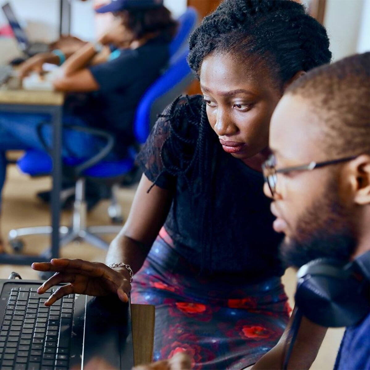 Two people sat at computer together