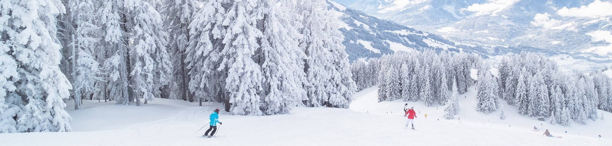 People skiing on snow-filled mountains